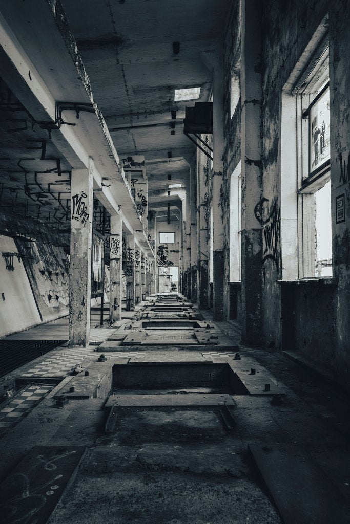 Raul Ling - Moody interior shot of an abandoned industrial space with visible graffiti and decay.