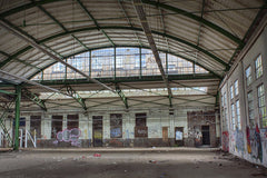 Antonio Friedemann - Interior of an abandoned warehouse with graffiti and debris, showcasing urban decay.
