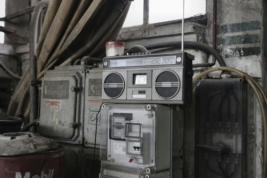Andrea Piacquadio - Old fashioned cassette player placed in shabby garage near old industrial equipment