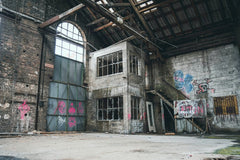 Timo Scheiler - Explore this decaying warehouse with vibrant graffiti art covering its walls.