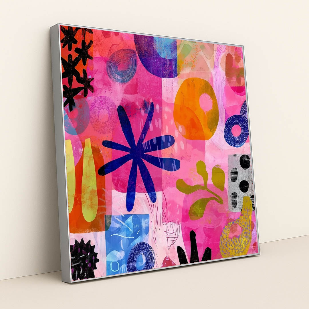 This artwork shows a colorful abstract collage with organic shapes, blue flowers, circles, and vibrant pinks and oranges, in a silver frame.