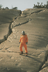 Stephen Leonardi - A person in an alien costume stands on cracked rocky ground, portraying a sci-fi scene.