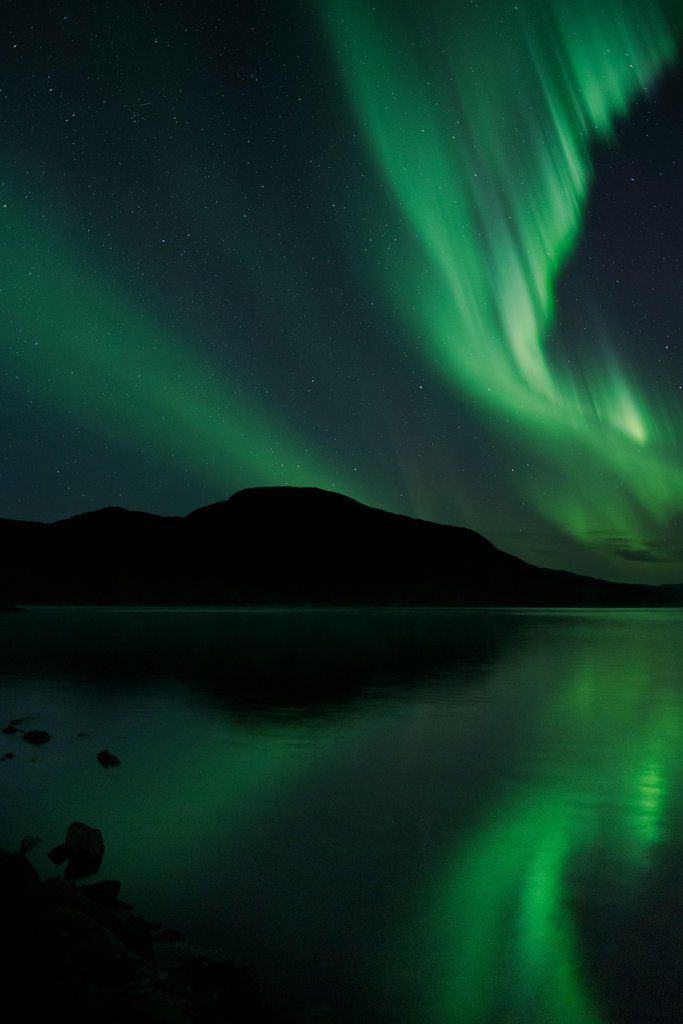 The aurora bore is reflected in the water by Christoph Nolte