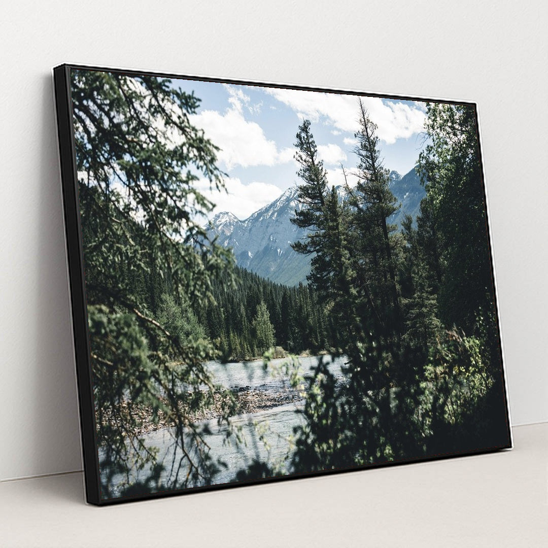 Snow-Capped Rocky Mountains and Evergreen Forest by River in Banff by Ali Kazal - Black Frame Stretchiez