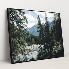 Snow-Capped Rocky Mountains and Evergreen Forest by River in Banff by Ali Kazal - Black Frame Stretchiez