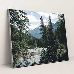 Snow-Capped Rocky Mountains and Evergreen Forest by River in Banff by Ali Kazal - Silver Frame Stretchiez