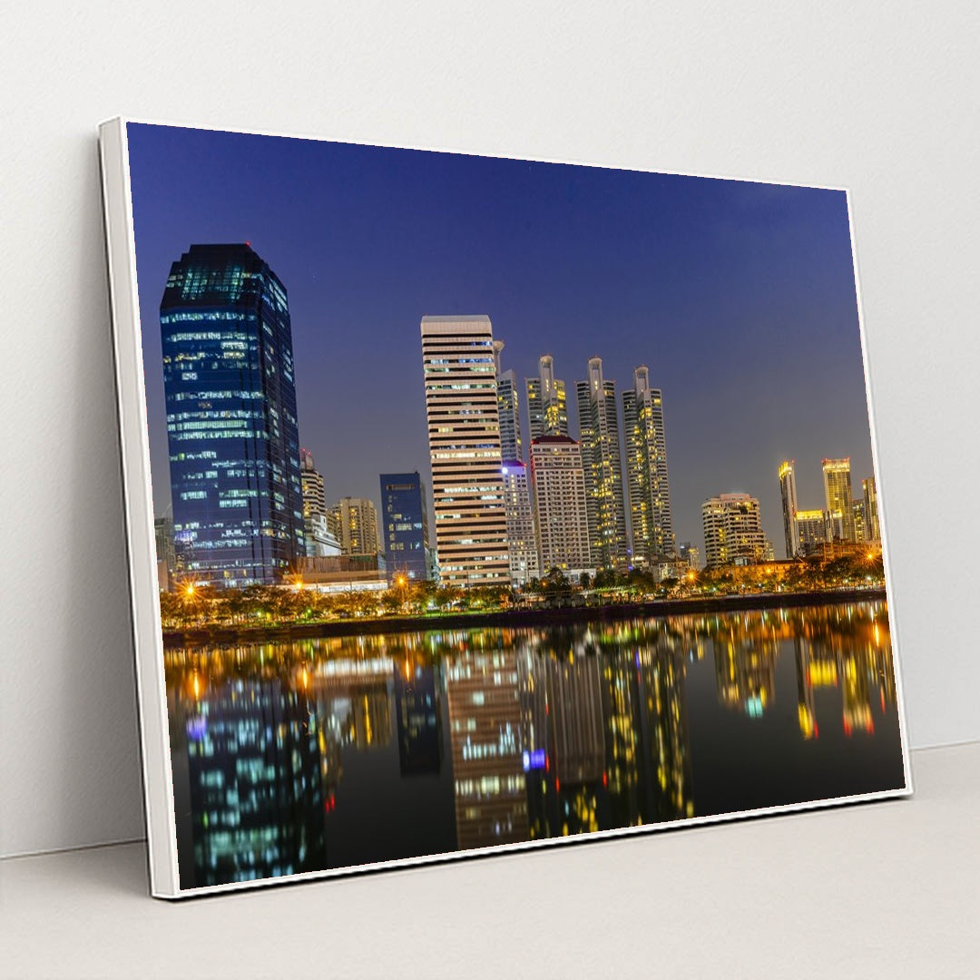 Nighttime Bangkok's Riverfront Skyline by Anonymous - White Frame Stretchiez
