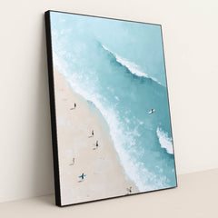 Ocean Whisper artwork features a bright beach scene with surfers carrying boards along the sand beside turquoise ocean waves, displayed in a black frame.