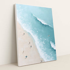 Ocean Whisper artwork features a bright beach scene with surfers carrying boards along the sand beside turquoise ocean waves, displayed in a white frame.