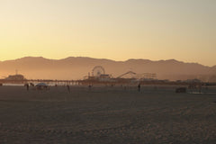 Jesse R - Beautiful sunset view of Santa Monica Pier with silhouettes against a vibrant sky.
