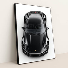 This photo shows a top-down view of a black Porsche 911 against a white background, in a black frame.