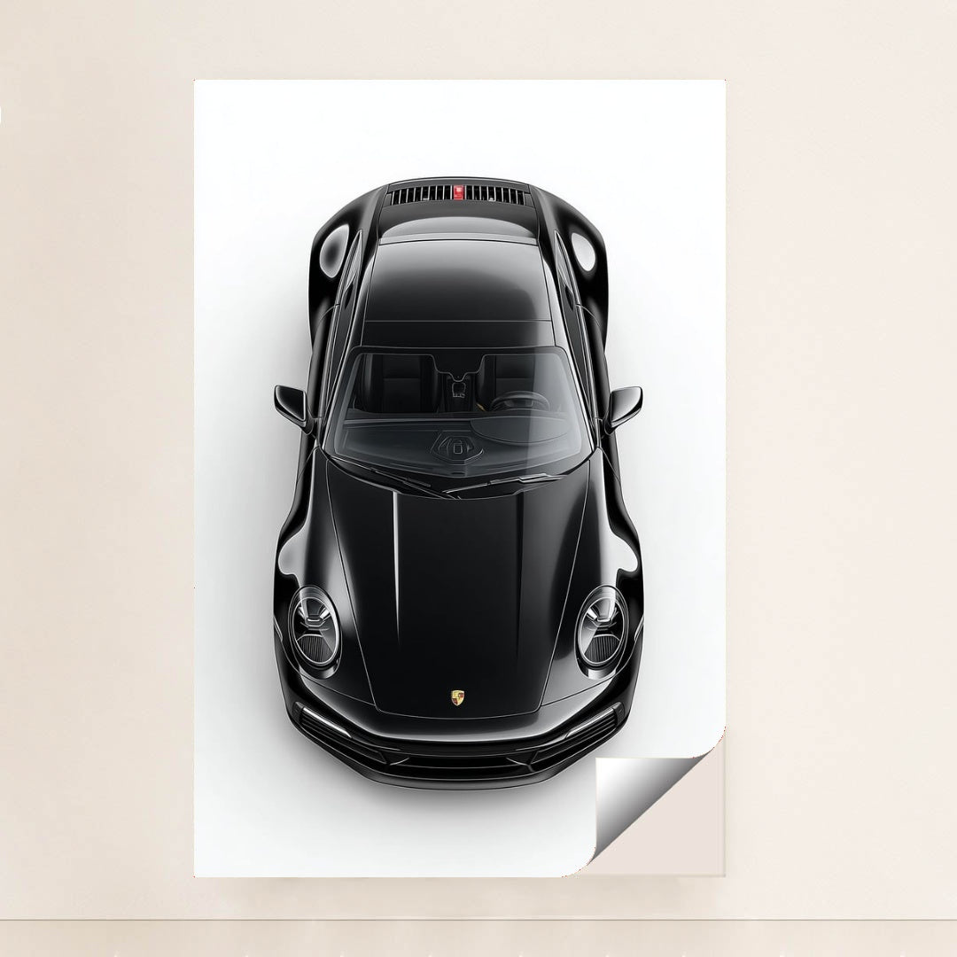 This photo shows a top-down view of a black Porsche 911 against a white background, unframed.