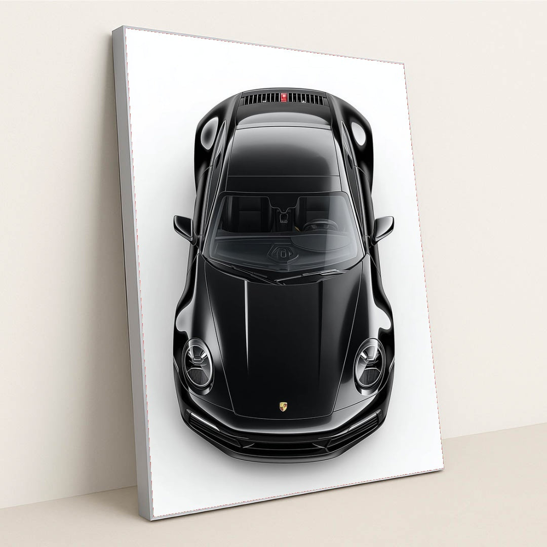This photo shows a top-down view of a black Porsche 911 against a white background, in a silver frame.