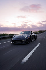 Porsche 911 GT3 Sunset Drive car wall art featuring a sleek black supercar on a coastal highway at sunset.