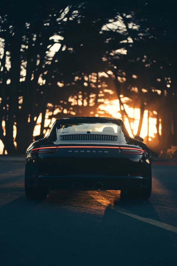 Porsche 911 Carrera 4s at Golden Hour, a black car parked with sunset glow, perfect for car wall art.