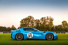 Ferrari F12tdf Sunset Glow in sky-blue color on grass with sunset background, showcasing car wall art features.