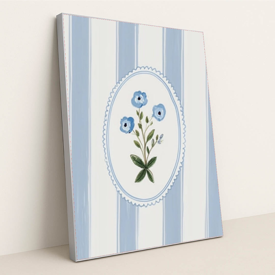 This artwork features a blue floral motif in an oval frame over vertical blue and white stripes, in a silver frame.