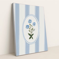 This artwork features a blue floral motif in an oval frame over vertical blue and white stripes, in a silver frame.