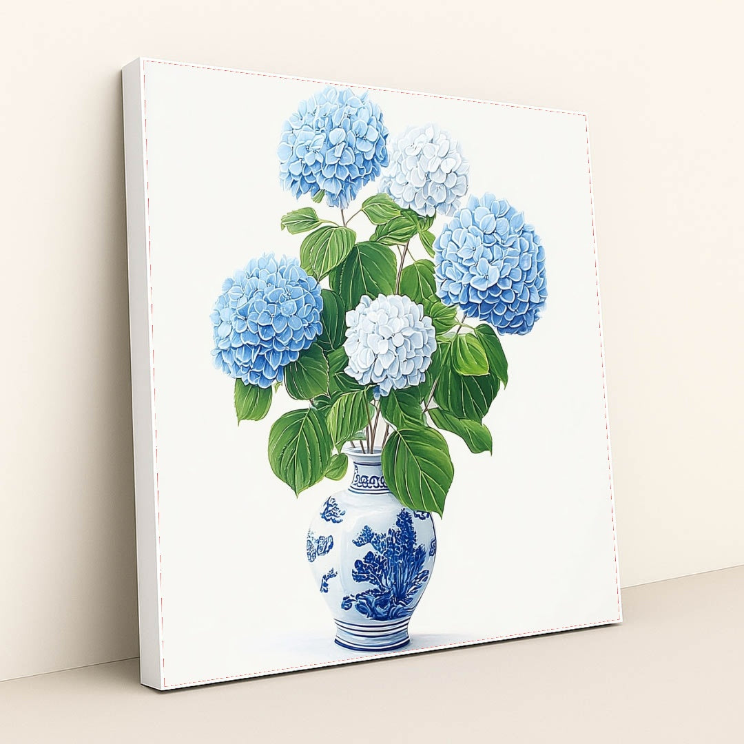 This artwork features a bouquet of blue and white hydrangeas in a blue and white porcelain vase, in a white frame.