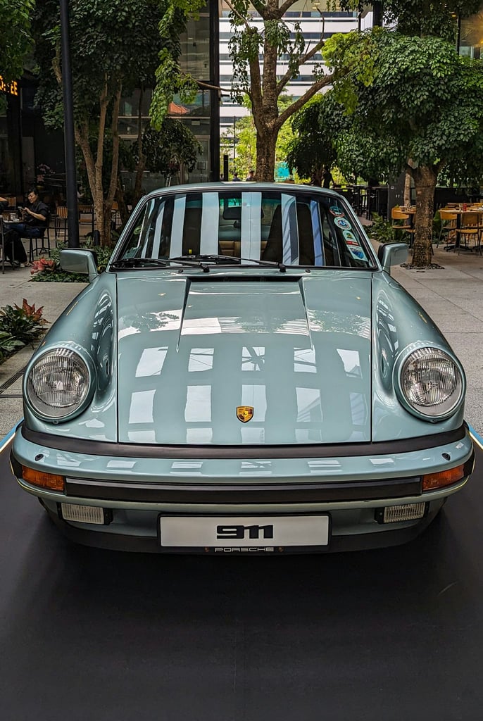 Porsche 911 Resting on a Quiet Street, showcasing classic design in a serene outdoor setting, ideal car wall art.
