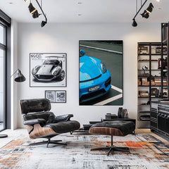 Blue Porsche 911 Resting After Rain wall art displayed in a modern living room, showcasing sleek design and vivid color.