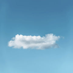 Stanislav Kondratiev - A lone fluffy cloud set against a bright blue sky, showcasing serene simplicity.
