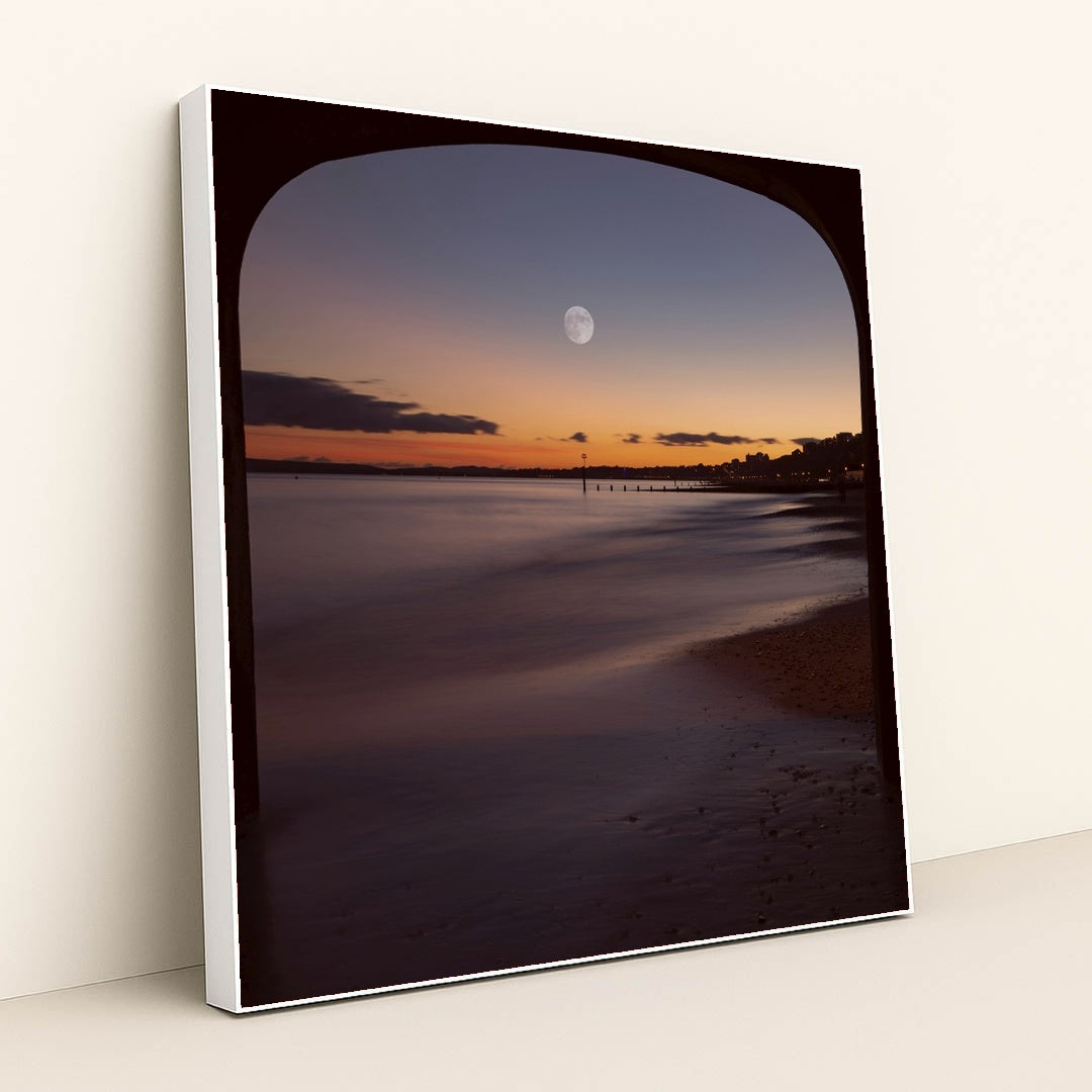 Moonlit Evening View Under Bournemouth Pier with Illuminated Coastline by Mohammad Abbasi - White Frame Stretchiez