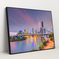 Sunset Serenity: Brisbane Skyline and River View by Anonymous - Black Frame Stretchiez