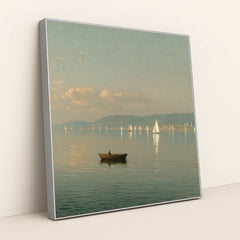 Peaceful lake scene with a rowboat and distant sailboats, soft sky, and mountains, in a silver frame.