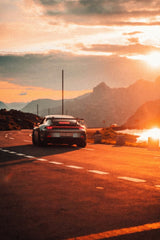 Porsche 911 GT3 Sunset Drive on a scenic road during sunset, ideal for car wall art.
