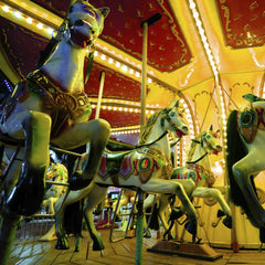 Engin Akyurt - Vibrant carousel horses illuminated by lights at an amusement park, exuding a nostalgic carnival atmosphere.