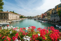 Flower-Lined Canal in an Italian Town by Getty Images