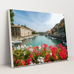 Flower-Lined Canal in an Italian Town by Getty Images - White Frame Stretchiez