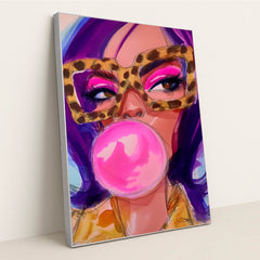 This artwork shows a stylized woman with purple hair, bold pink eyeshadow, leopard-print glasses, and a large pink bubblegum bubble, in a silver frame.