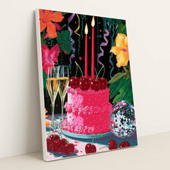This artwork shows a festive pink cake with cherries, two lit candles, champagne glasses, a disco ball, and colorful hibiscus flowers, in a white frame.