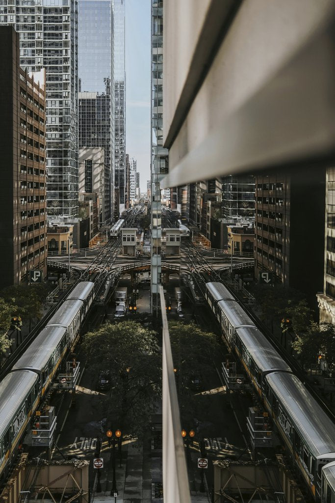 Steve Cancel - Atmospheric urban view of Chicago's elevated railway and architecture with a striking reflection effect.