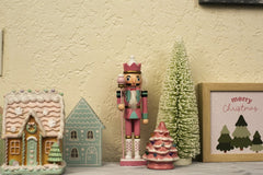 Juan Hernandez Jr - Charming Christmas decorations featuring a pink nutcracker and festive trees indoors.