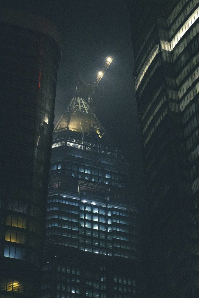 Yiğit  KARAALİOĞLU - Mystical night cityscape featuring illuminated skyscrapers in an urban setting.