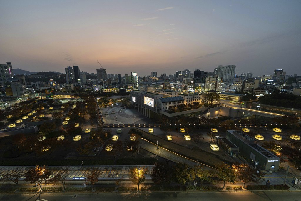 Asia Culture Center - Beautiful aerial view of Gwangju cityscape during twilight with illuminated landmarks and urban architecture.
