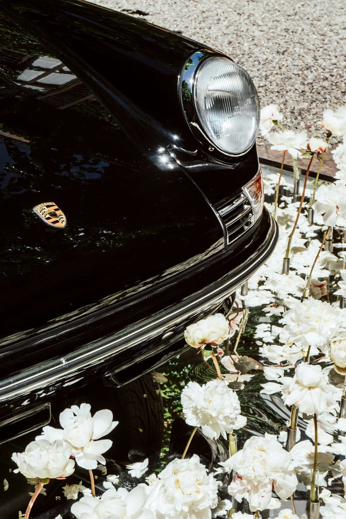 Classic Porsche Among White Peonies by Justus Menke