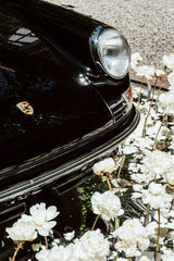 Classic Porsche Among White Peonies by Justus Menke