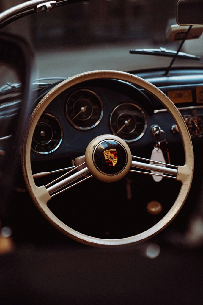 A Peek Inside the Porsche 356 steering wheel and dashboard showcasing luxury and craftsmanship, perfect for car wall art.