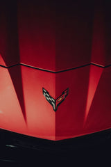Close-Up of a Red Corvette Hood by Marcel Strauß