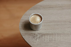 Cup of  Couple - A rustic coffee cup filled with hot beverage on a simple wooden table, viewed from above.