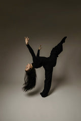 Lazarus Ziridis - A dancer in a dynamic black outfit performing an elegant contemporary pose.