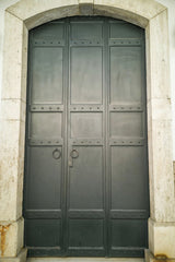 Engin Akyurt - A striking vintage metal door with a stone arch entrance, classic architectural style.