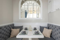 Max Vakhtbovycn - A contemporary dining nook with plush seating and stylish tableware, perfect for cozy gatherings.