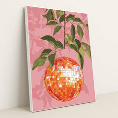 This artwork shows an orange disco ball hanging from a leafy branch against a pink background, in a white frame.