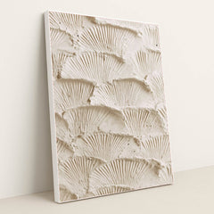 This artwork features overlapping fan-shaped textured cream plaster scales, in a white frame.