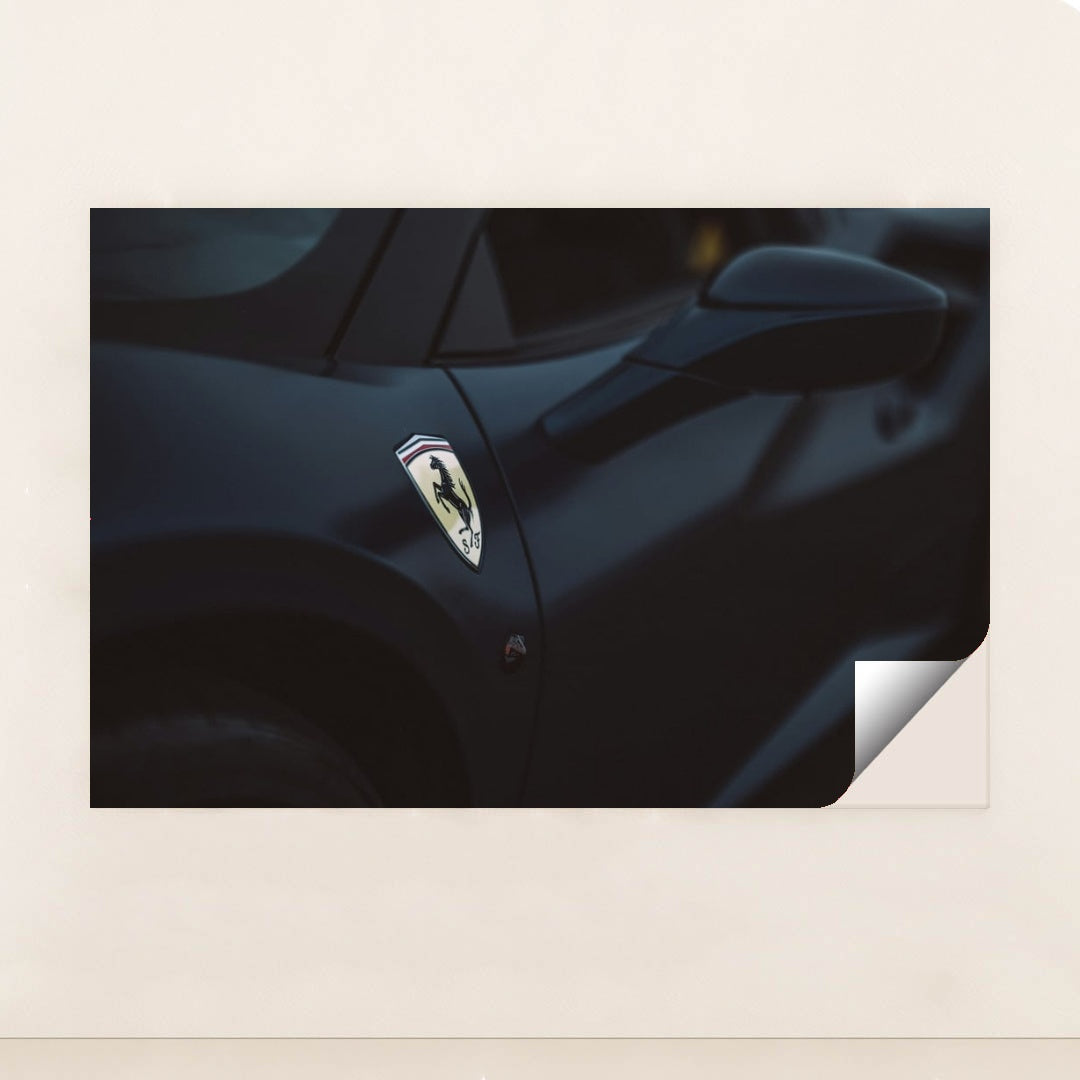 This photo shows a close-up of a dark blue Ferrari's front fender and side mirror with the Prancing Horse badge, unframed style.